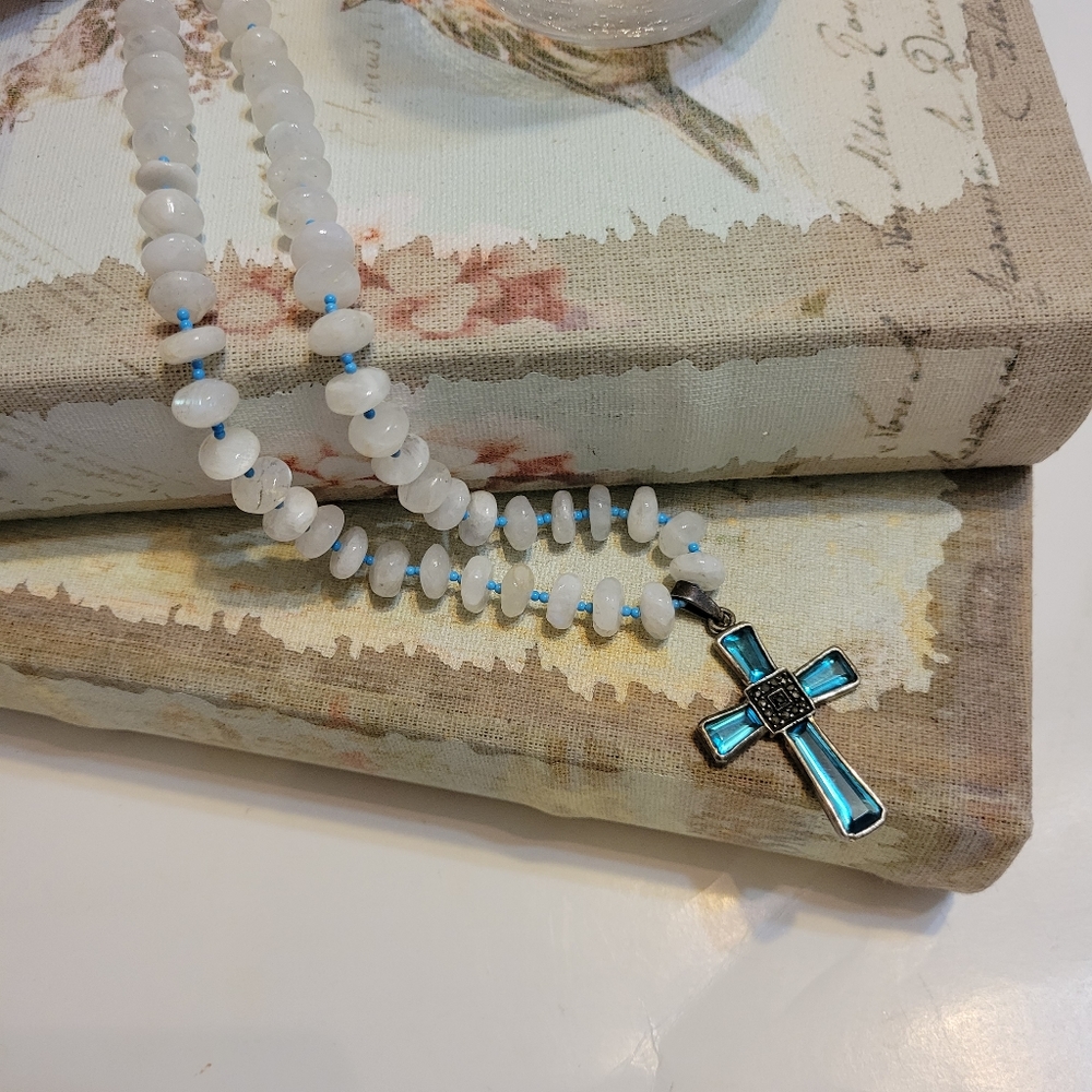 Beautiful blue glass cross necklace with knotted stone.